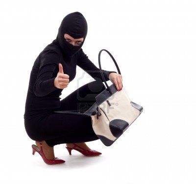 7613172-female-thief-in-black-balaclava-with-stolen-bag-thumb-up.jpg